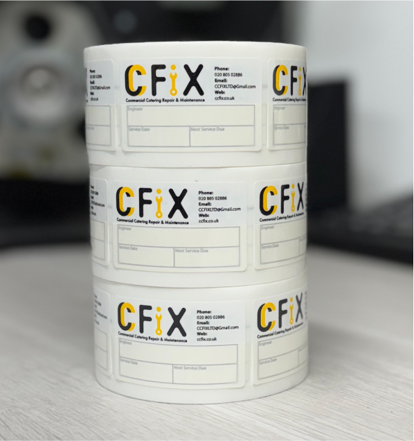 Engineer applying a write & seal service sticker to equipment