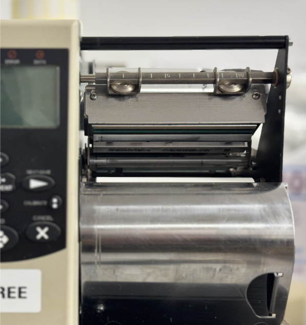 A thermal printer printhead being cleaned with a lint-free wipe