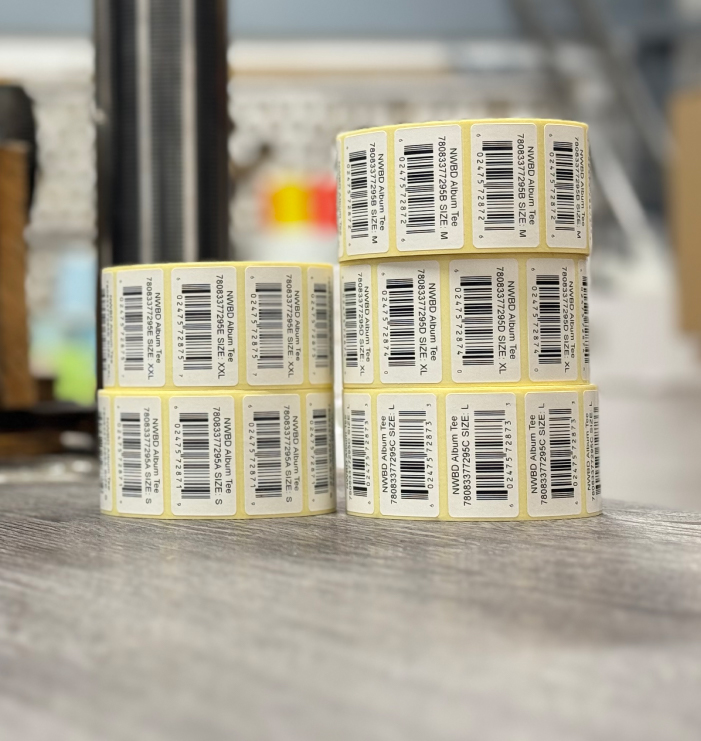 Close-up of printed barcode labels on a roll during production